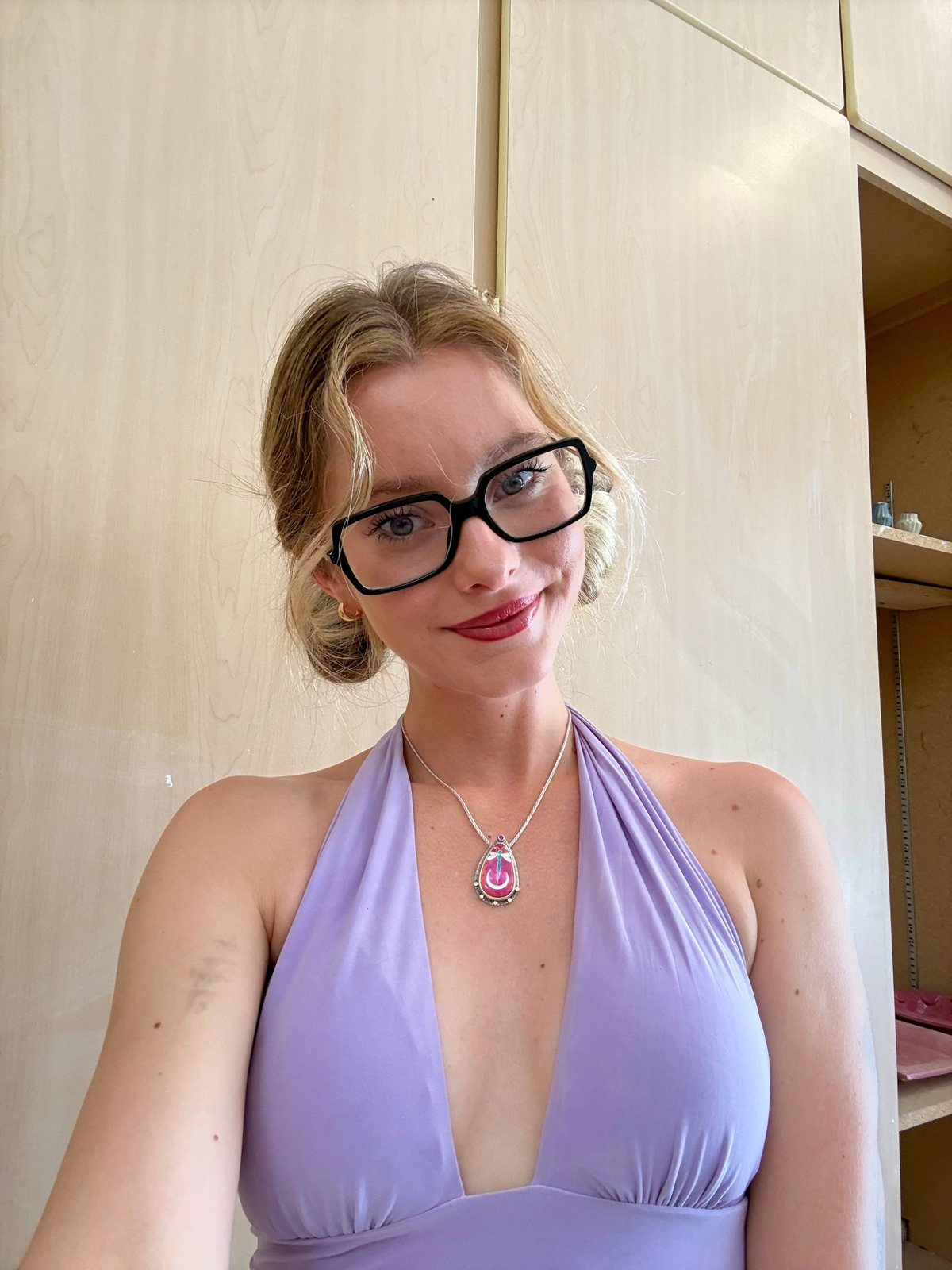 Haven smiling in glasses and a lavender halter top